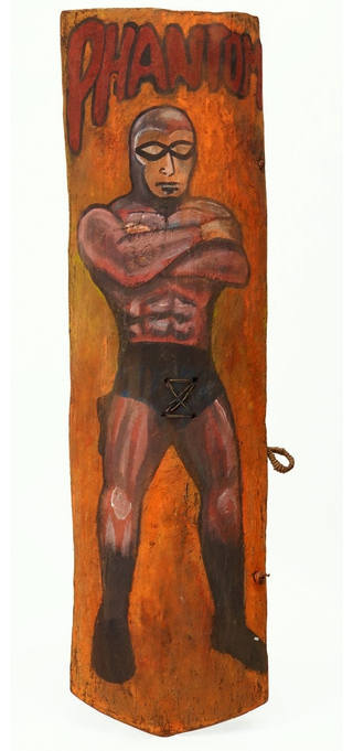 Illustration for article titled Why Does This Comic Book Hero Appear On So Many New Guinea War Shields?